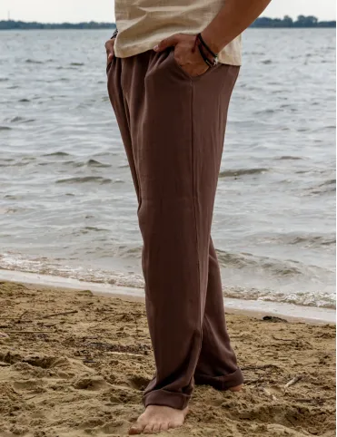Men's linen trousers with a loose fit and elasticated waistband.